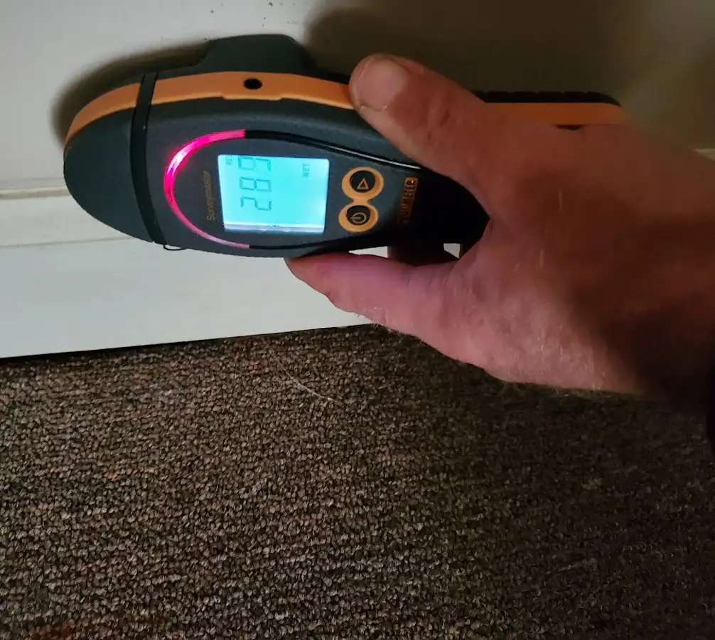 Moisture detection at baseboard during Storm Damage Restoration in Dallas